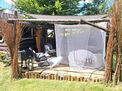 a gazebo with a chair in a yard at Małopolskie Swojskie in Olszyny