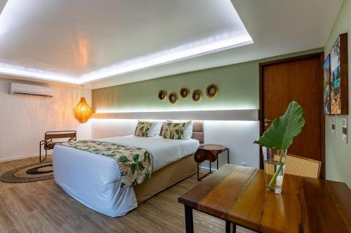a hotel room with a bed and a table at Dolphin Hotel in Fernando de Noronha