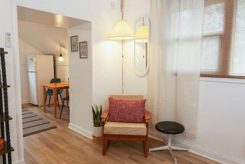 a living room with a chair and a table at Classic & Cozy Apartments - Parking & Close To Dw in Medford