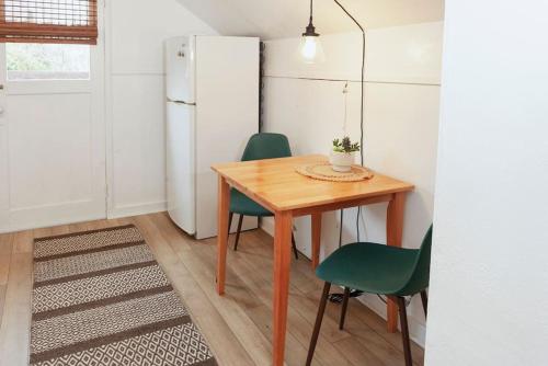 a kitchen with a table and chairs and a refrigerator at Classic & Cozy Apartments - Parking & Close To Dw in Medford