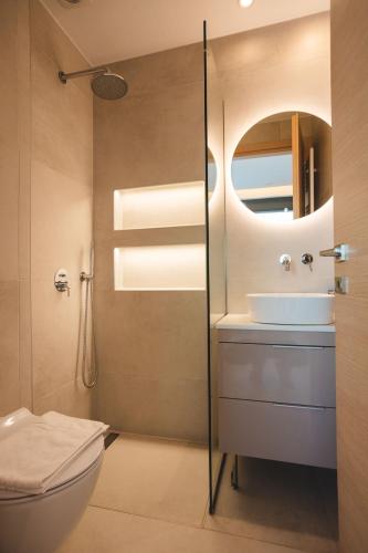 a bathroom with a toilet and a sink at Panoramic Villa in Tolo