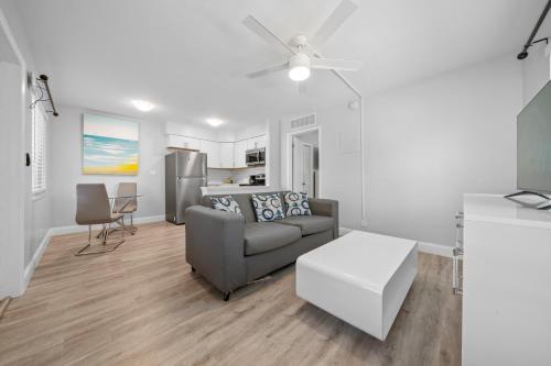 a living room with a couch and a table at Riverbend Apartments by Lowkl in Fort Lauderdale
