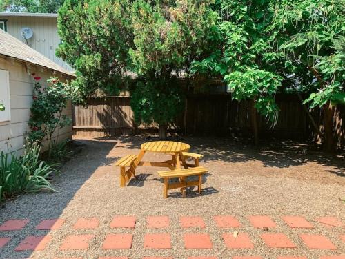 a picnic table and a bench in a yard at Classic & Cozy Apartments - Parking & Close To Dw in Medford