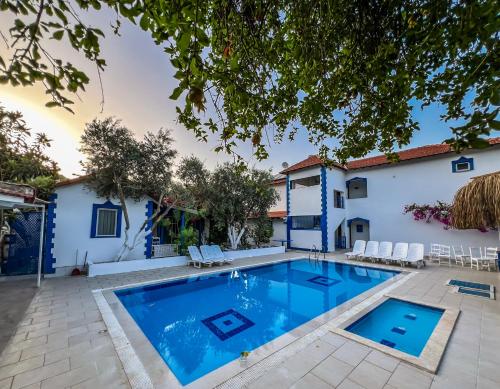 a swimming pool in the backyard of a house at Pineloft Selimiye in Mugla