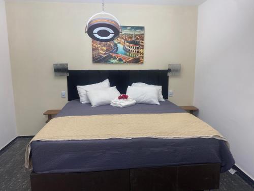 a bedroom with a large bed with a blue comforter at Pousada Vila Italia - Porto da Dunas in Aquiraz