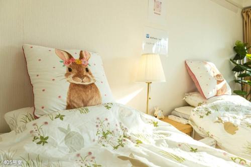 a stuffed rabbit is sitting on top of a bed at Nanei Building - Vacation STAY 47399v in Kagoshima