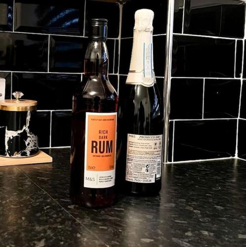 two bottles of wine sitting on top of a counter at Simple House w- FREE PARKING by Manchester Airport - FREE DROP-OFF in Manchester