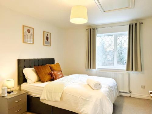 a bedroom with a bed and a window at Simple House w- FREE PARKING by Manchester Airport - FREE DROP-OFF in Manchester