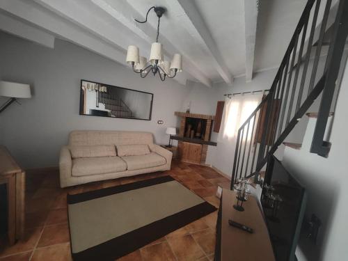 a living room with a couch and a table at Ca la Marta in Santa Liña