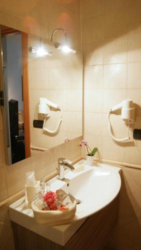 a bathroom with a sink and a mirror at Catia Sweet Holiday 2 in Fiumicino