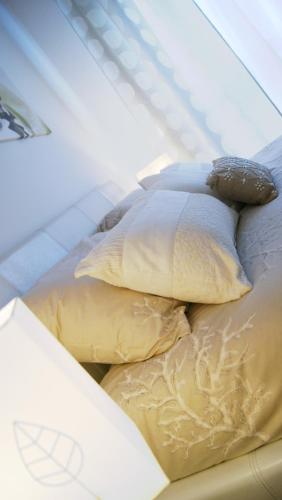 two pillows sitting on top of a bed at Catia Sweet Holiday 2 in Fiumicino