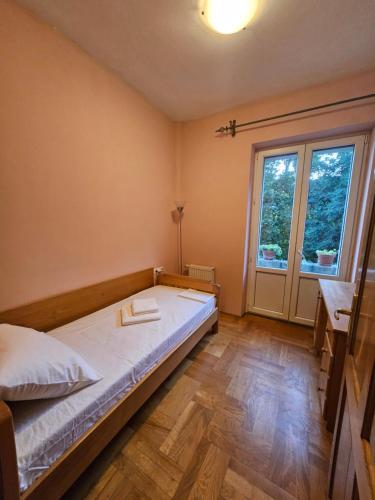 a bedroom with a bed and a large window at Saint George Apartment in Split