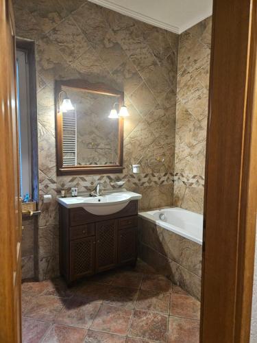 a bathroom with a sink and a bath tub at Saint George Apartment in Split