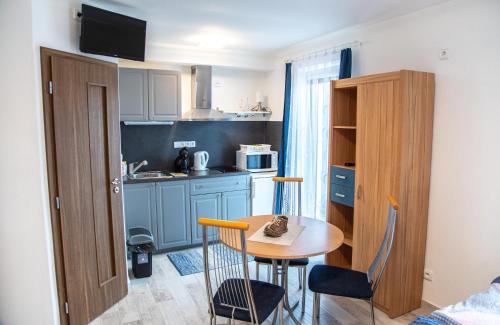 a small kitchen with a table and chairs in a room at Panská in Chlum u Třeboně