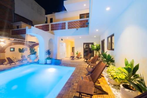 a villa with a swimming pool in a yard at Casa Victoria Malecón - Adults Only in Puerto Vallarta