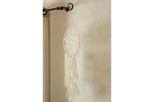 a dream catcher hanging on a wall at Dobilyne Homestead in Gražiškiai