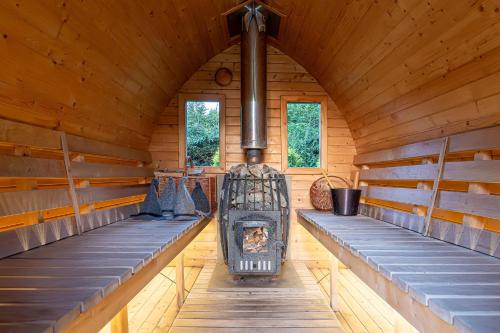 an inside view of a log cabin with a fireplace at Dobilyne Homestead in Gražiškiai