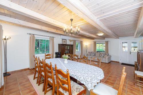 a dining room with a table and chairs at Dobilyne Homestead in Gražiškiai