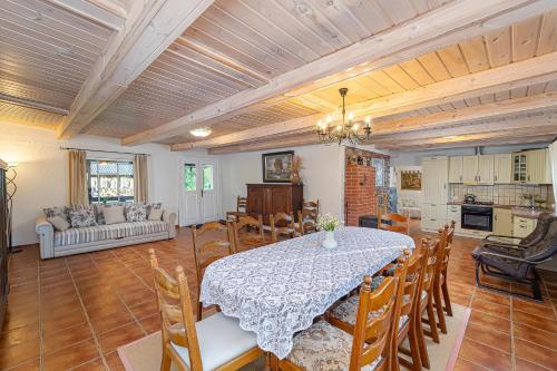 a dining room with a table and a kitchen at Dobilyne Homestead in Gražiškiai