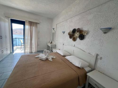 a bedroom with a bed with a white flower on it at Marinas Studios in Livadia