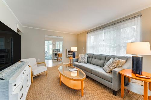 a living room with a couch and a table at Bayfront East Quogue Retreat with Private Boat Dock in East Quogue