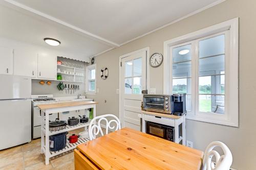 a kitchen with a table and a refrigerator and a stove at Bayfront East Quogue Retreat with Private Boat Dock in East Quogue