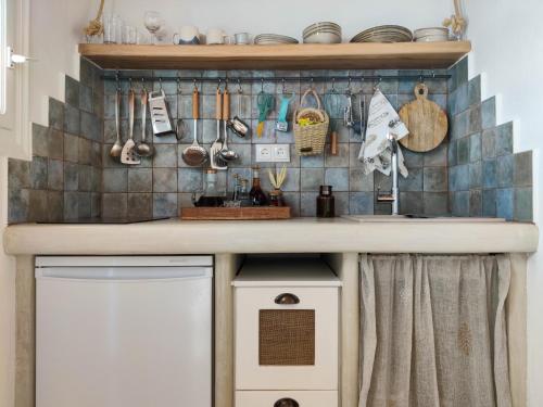 a kitchen with a sink and a counter with utensils at Dafne & Chloe Terrace Studios in Naxos Chora