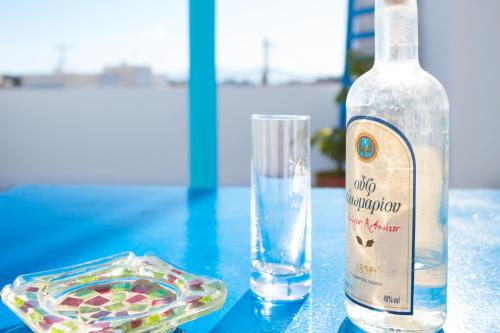 a bottle of water and a glass on a table at Dafne & Chloe Terrace Studios in Naxos Chora