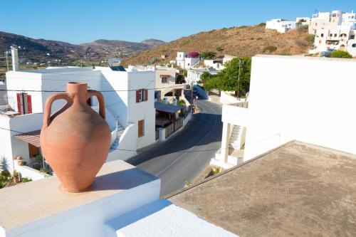 a vase sitting on the ledge of a building at Dafne & Chloe Terrace Studios in Naxos Chora