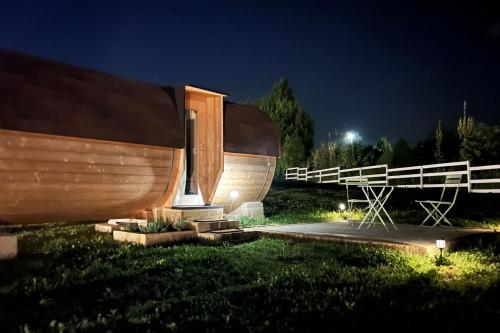 a wooden boat sitting in the grass at night at Notte nella Botte in Vignale Monferrato