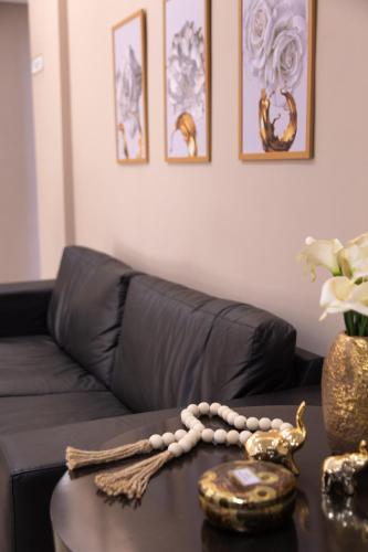 a living room with a black couch and a table at BOMBONATO HOTEL - Fácil Acesso ao Aeroporto e parque de Exposições ABCZ in Uberaba
