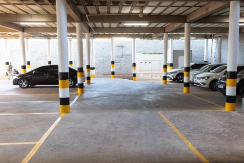 a parking garage with cars parked in it at BOMBONATO HOTEL - Fácil Acesso ao Aeroporto e parque de Exposições ABCZ in Uberaba