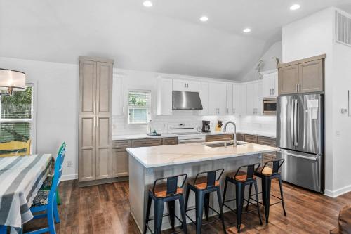 a kitchen with a island with bar stools at Fripp Island 96 Davis Love Dr in Fripp Island