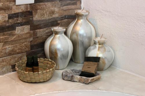 a group of three vases sitting on a counter at Hotel Boutique Casa Téllez in Maboro