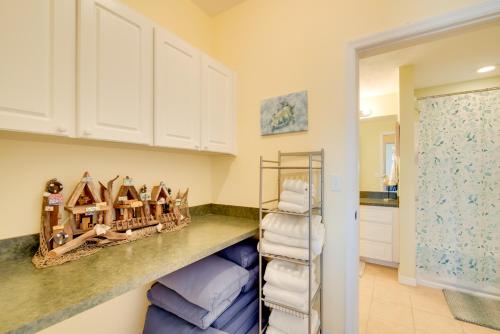a laundry room with a shelf with towels at Oceanfront Oasis in Cedar Key with 2 Balconies! in Cedar Key