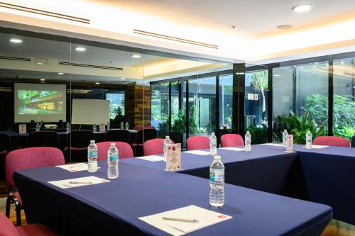 a meeting room with tables and chairs with water bottles at Las Suites Campos Eliseos in Mexico City