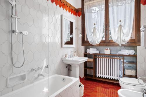 a bathroom with a tub and a sink and a toilet at Villa Pieve in Moncalvo