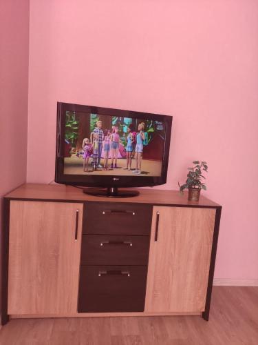 a flat screen tv sitting on top of a dresser at Oasis Apartments in Pärnu