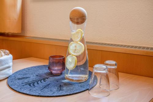 a glass vase with lemon slices in it on a table at Haus Waldhof in Ischgl