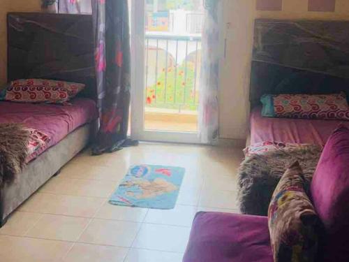a living room with two couches and a rug on the floor at Appartement résidence prive marina in Saidia 