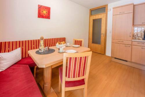 a dining room with a table and a couch at Haus Waldhof in Ischgl
