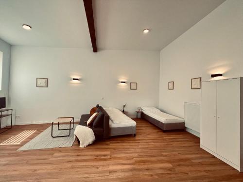 a woman laying on a bed in a room at M&N Apartments in Bad Bevensen
