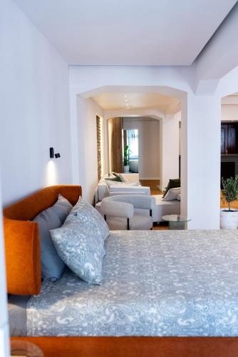 a bedroom with a bed and a living room at Thome Continental Suite in Cluj-Napoca