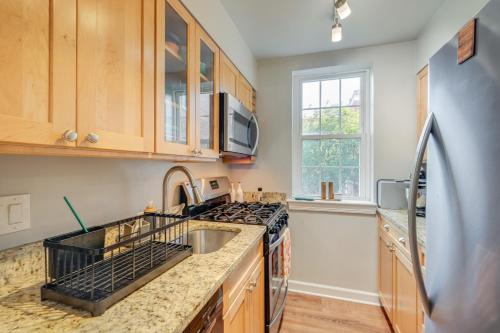 a kitchen with a sink and a stove at Convenient Arlington Condo about 4 Mi to National Mall in Arlington