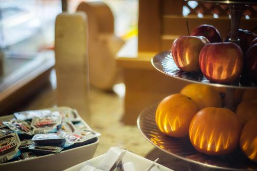 three plates of apples and oranges on a table at Hotel Augarten in Neustift im Stubaital
