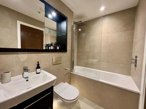 a bathroom with a sink and a toilet and a tub at The Card Room at Ryedale House in York
