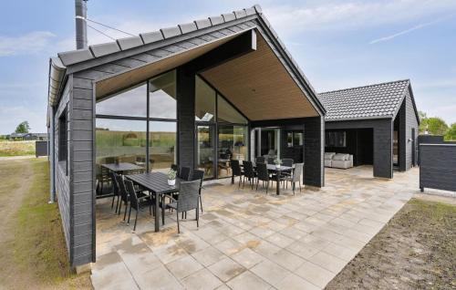 a pavilion with tables and chairs on a patio at Nice Home In Otterup With Sauna in Otterup