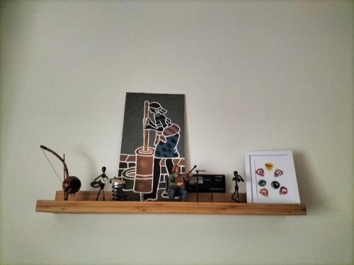 a shelf with a picture of a woman playing a guitar at Music and Words in Oeiras