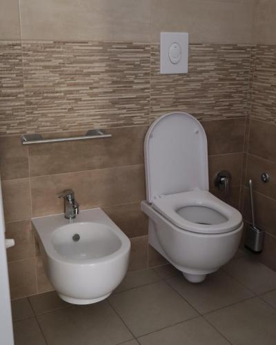 a bathroom with a toilet and a bidet at L'AQUILA Apartment in LʼAquila