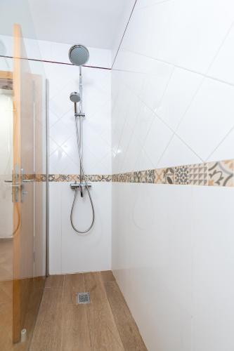 a shower in a bathroom with white walls at Calas Beach Corralejo in Corralejo
